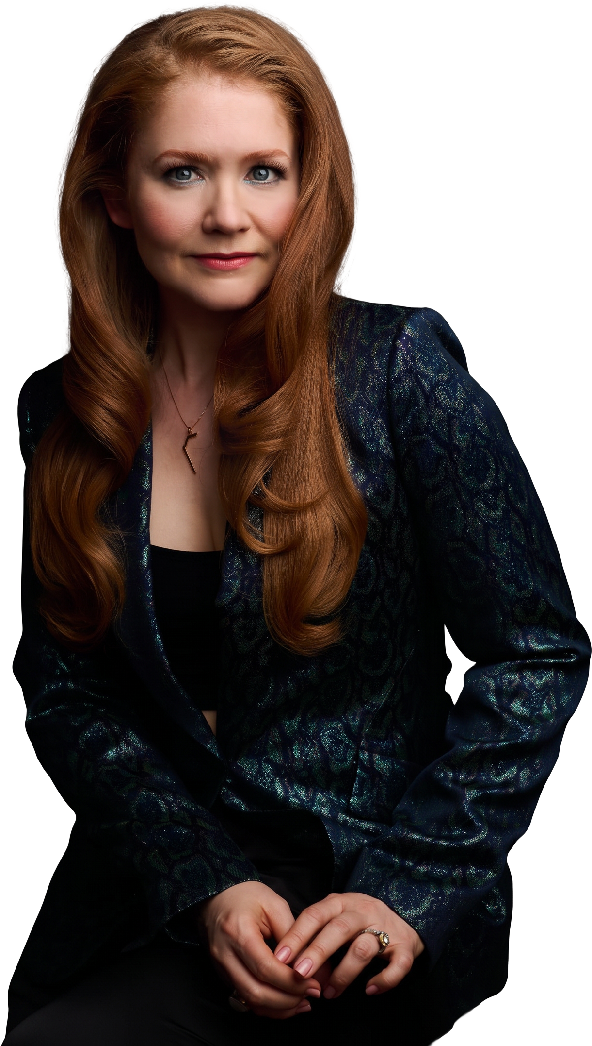 Charleene Closshey seated in a dark jacquard jacket